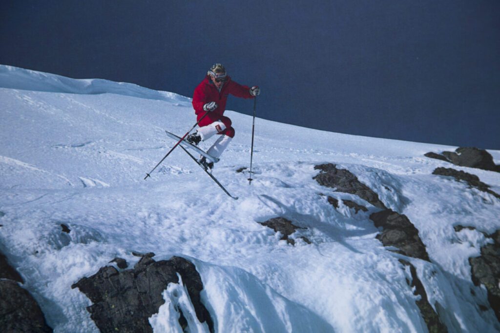 Vintage skier dropping a cliff