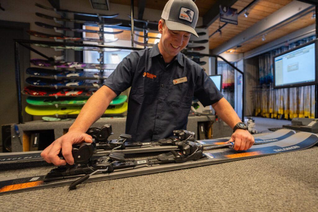 Rental expert setting up skis