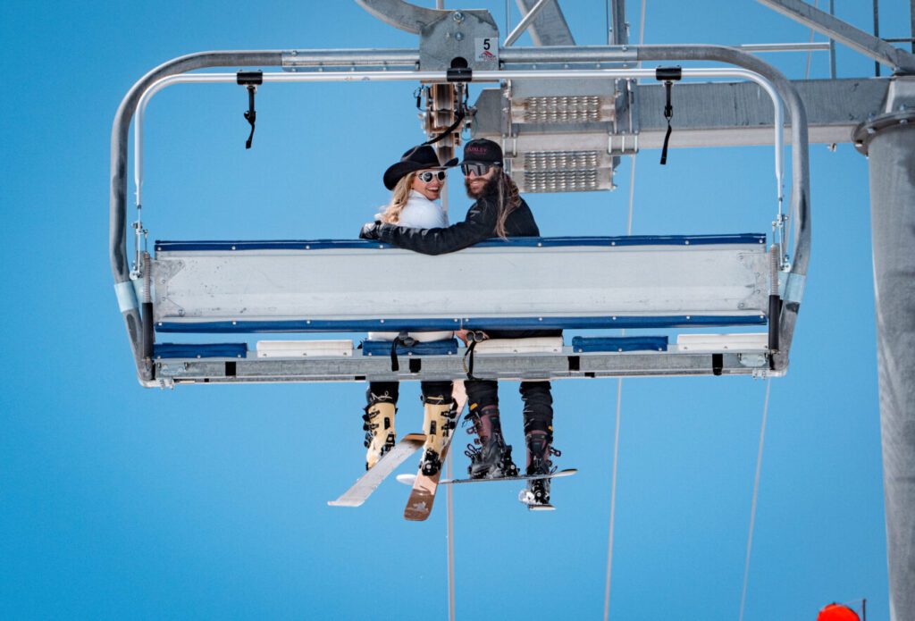 Amie and Todd smiling from chairlift