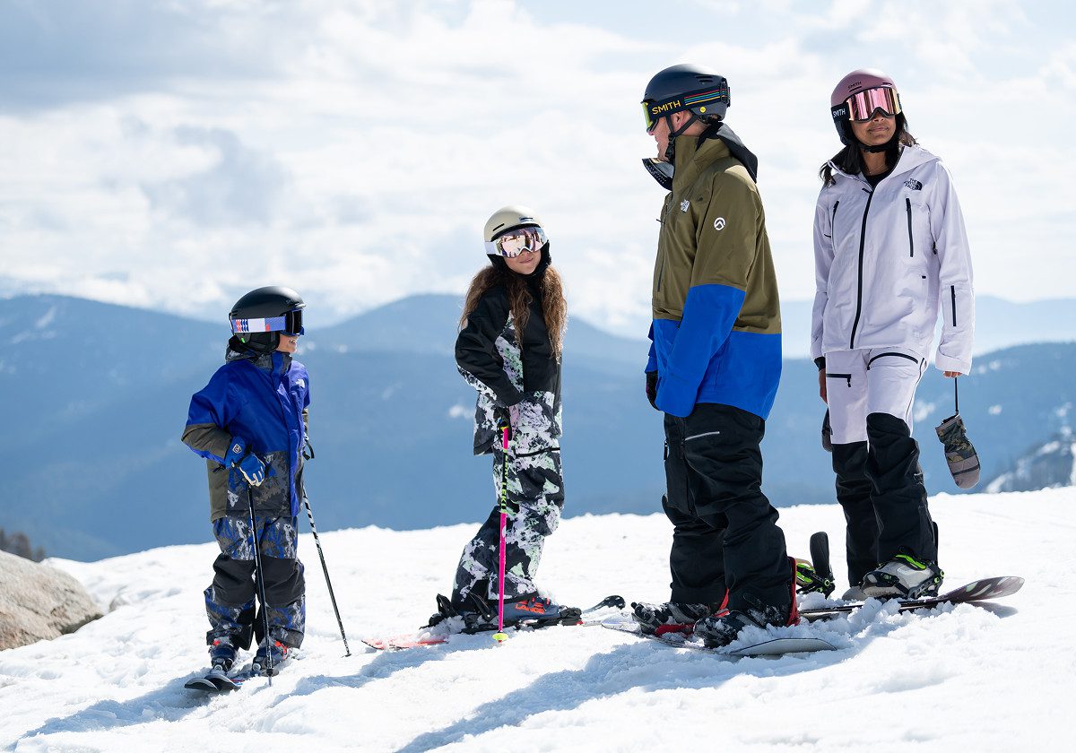 Family with two snowboarders and two skiers