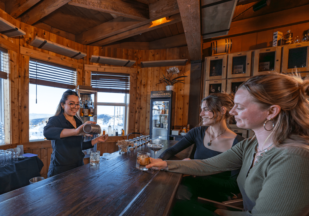 Two women getting drinks at Alexanders