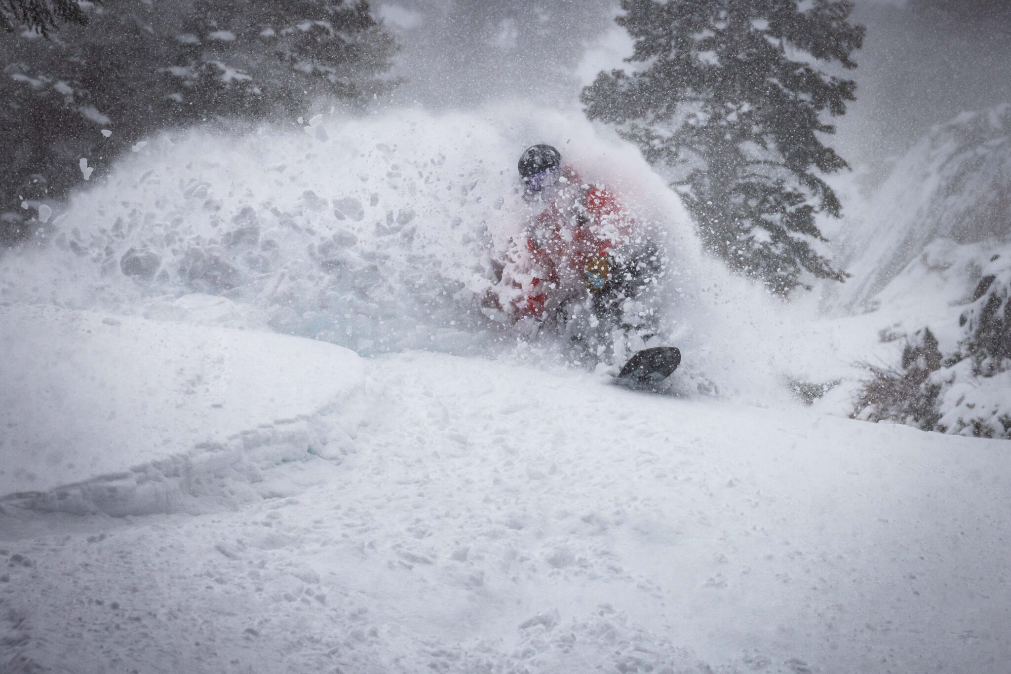 Snowboarder turns on powder on February 16, 2026.