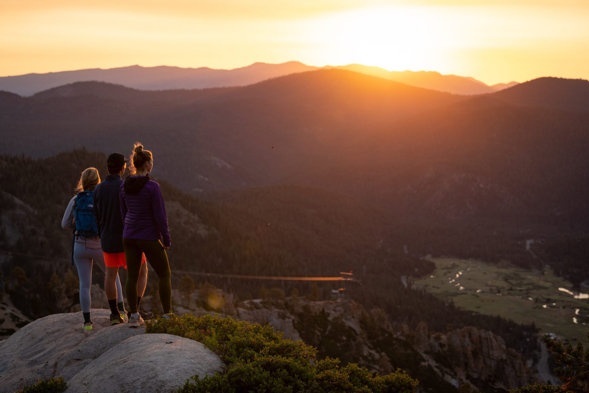 Three hikers overlooking Olympic Valley