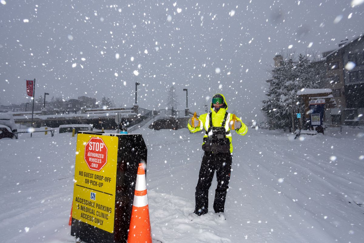Parking attendant posing for a picture on a snow day